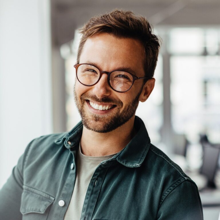 Young man with glasses smiling