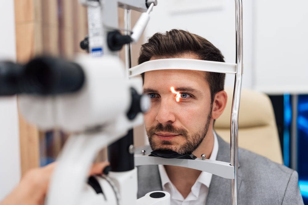 Man in his 40s at ophthalmologist checking eye vision